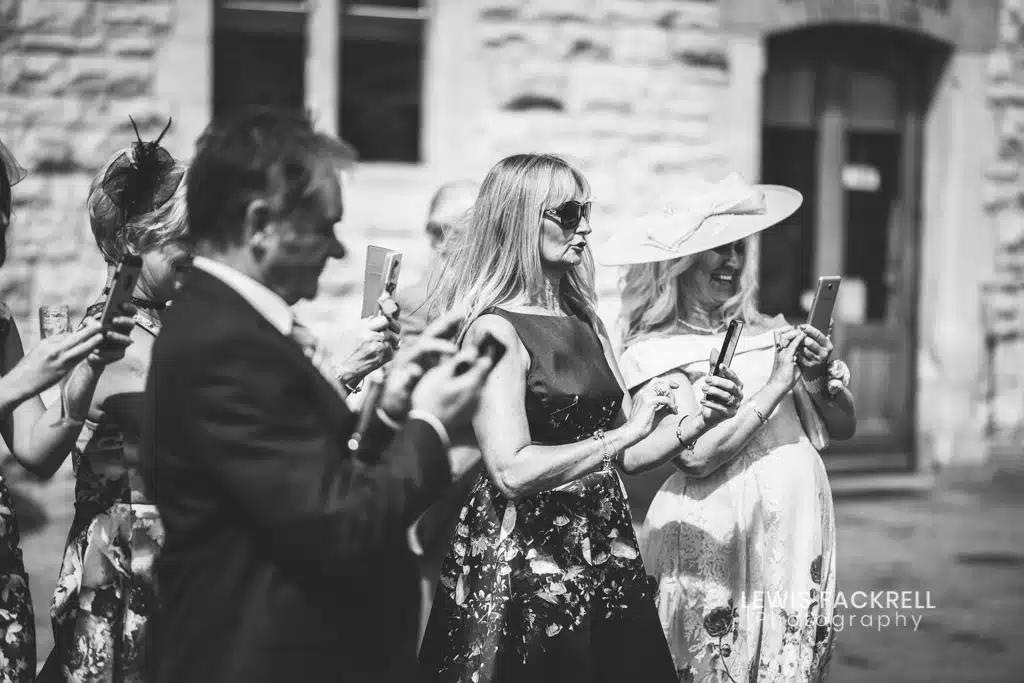 un-plugged-wedding-guests-taking-photos-iphones