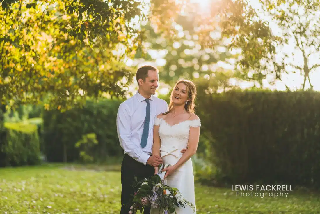Fonmon castle wedding photography of the bride and groom under a tree at sunset