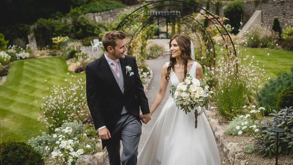 Fairyhill-wedding-photographer-capturing-Bride-Groom-wealking-around-gardens bride and groom walking around Fairyhill garden grounds
