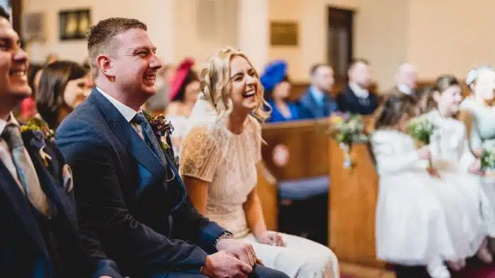 167-Wedding-Photography-at-Stone-Barn-Emma-Gavin-Lewis-Fackrell-Photography bride and groom laughing in church