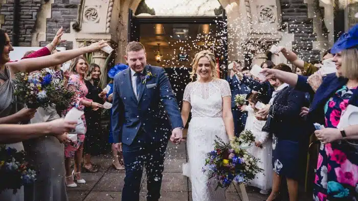 201-Wedding-Photography-at-Stone-Barn-Emma-Gavin-Lewis-Fackrell-Photography confetti thrown at bride and groom