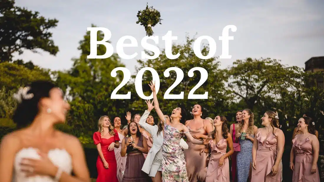 bouquet toss with brides and girls trying to catch the flowers in cotswolds