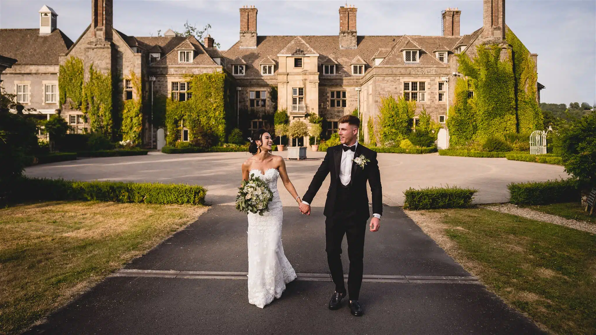 bride and groom walking around at Llangoed Hall in Mid-Wales.