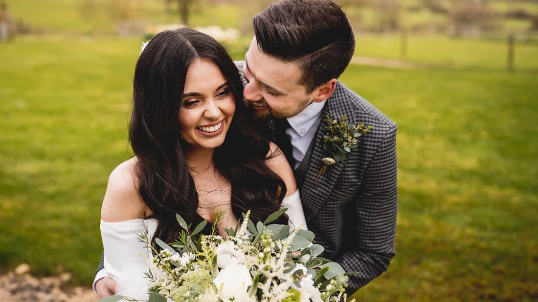 Couple holding each other during portrait time at Barn at Upcote in Cotswolds