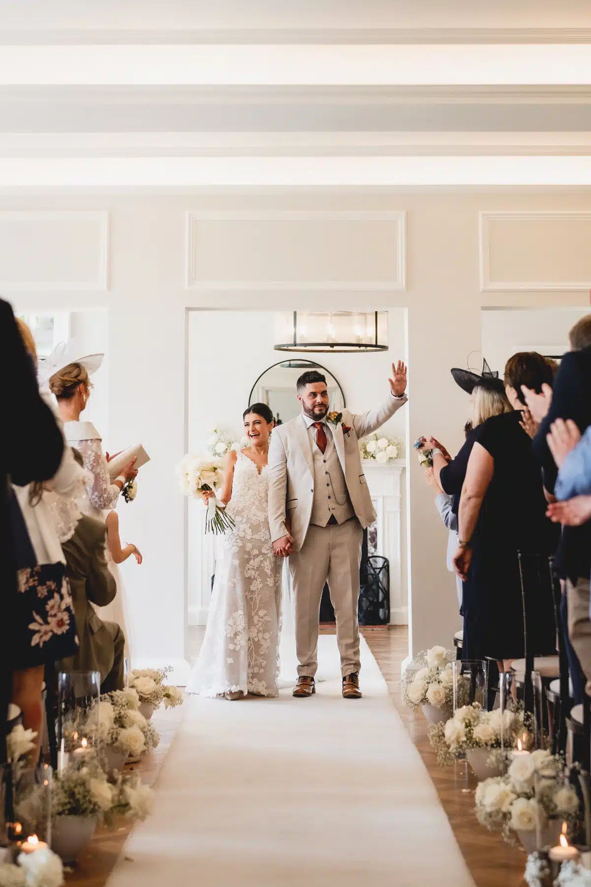 Sant Ffraed house ceremony room with newly married couple walking back down aisle.