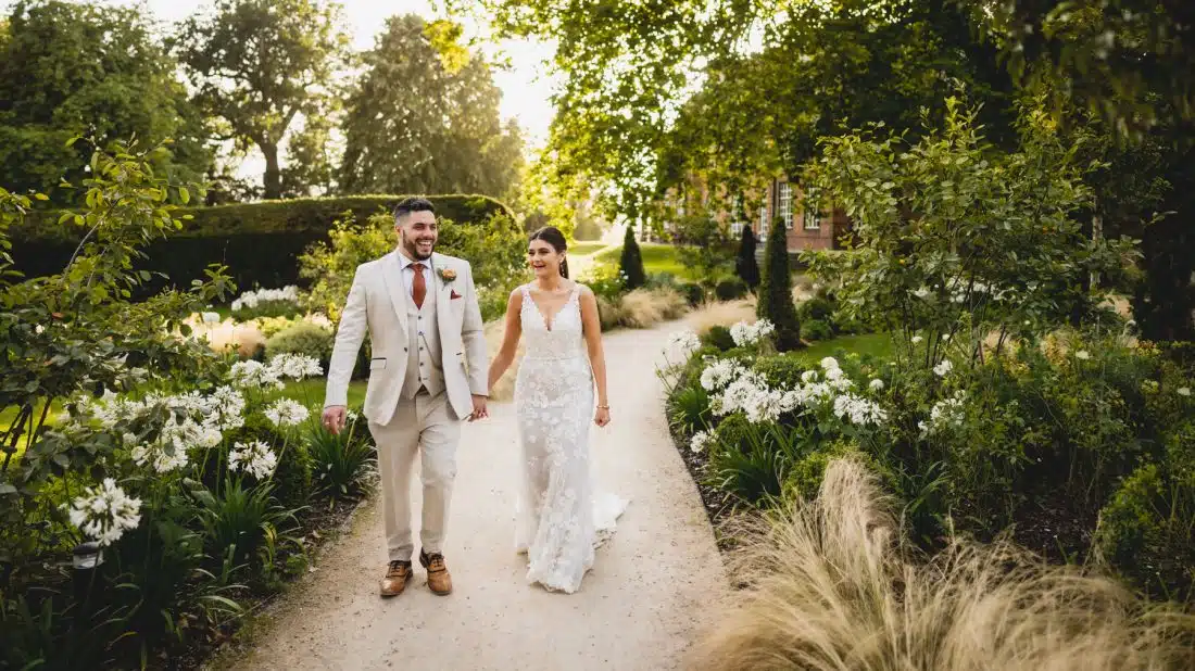 bride and groom walking back from Sant Ffraed House ceremony