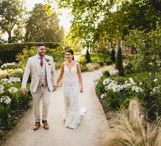 bride and groom walking back from Sant Ffraed House ceremony
