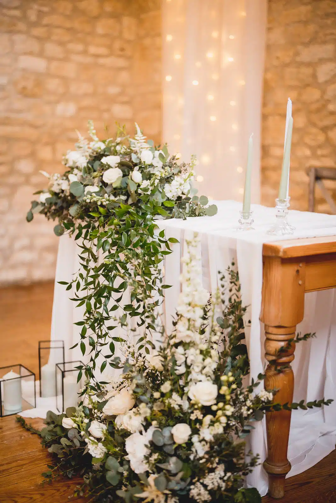 Flowers on the ceremony table inside the Barn at Upcote