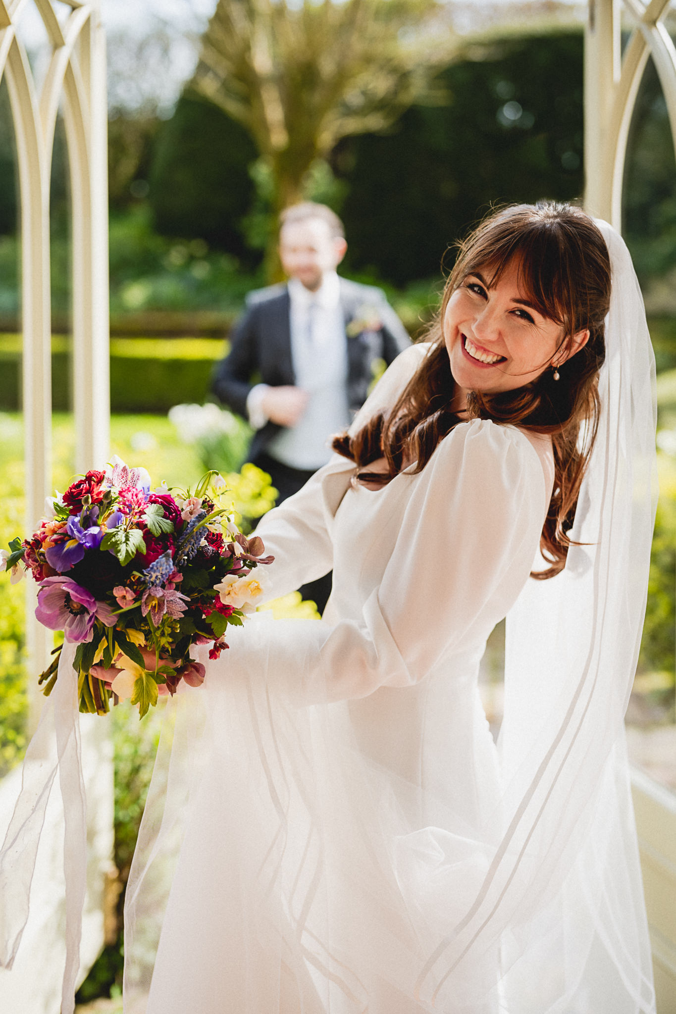 Bride with her bouquet in the garden at Dewsall Court