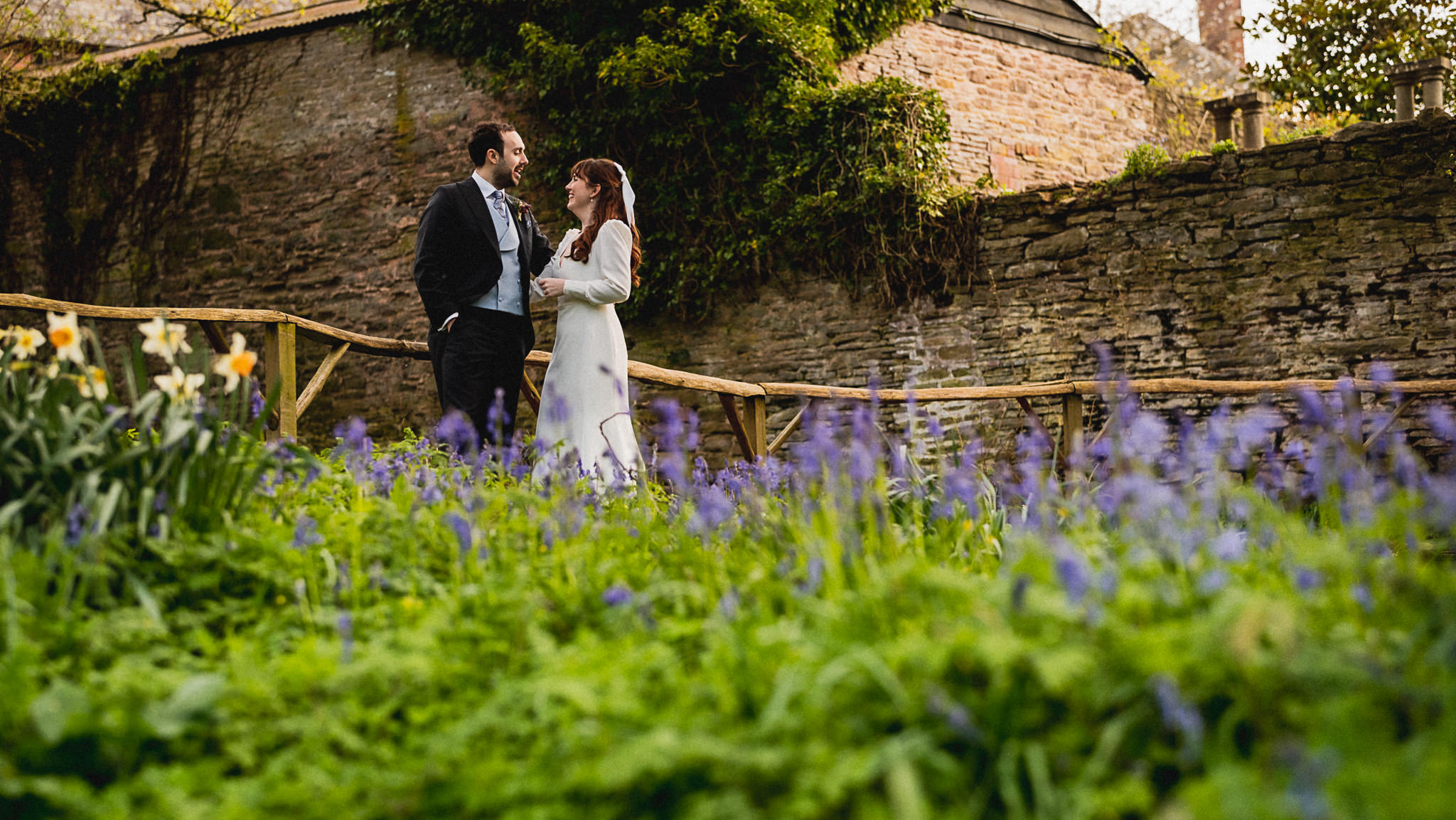 Couple among the bluebells at Dewsall Court