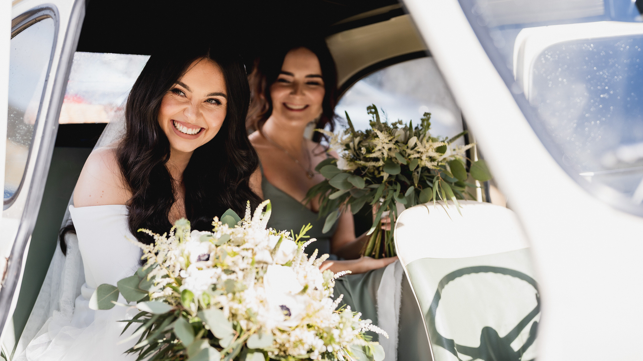 Bridesmaids in the back of the car on the way to the Barn at Upcote