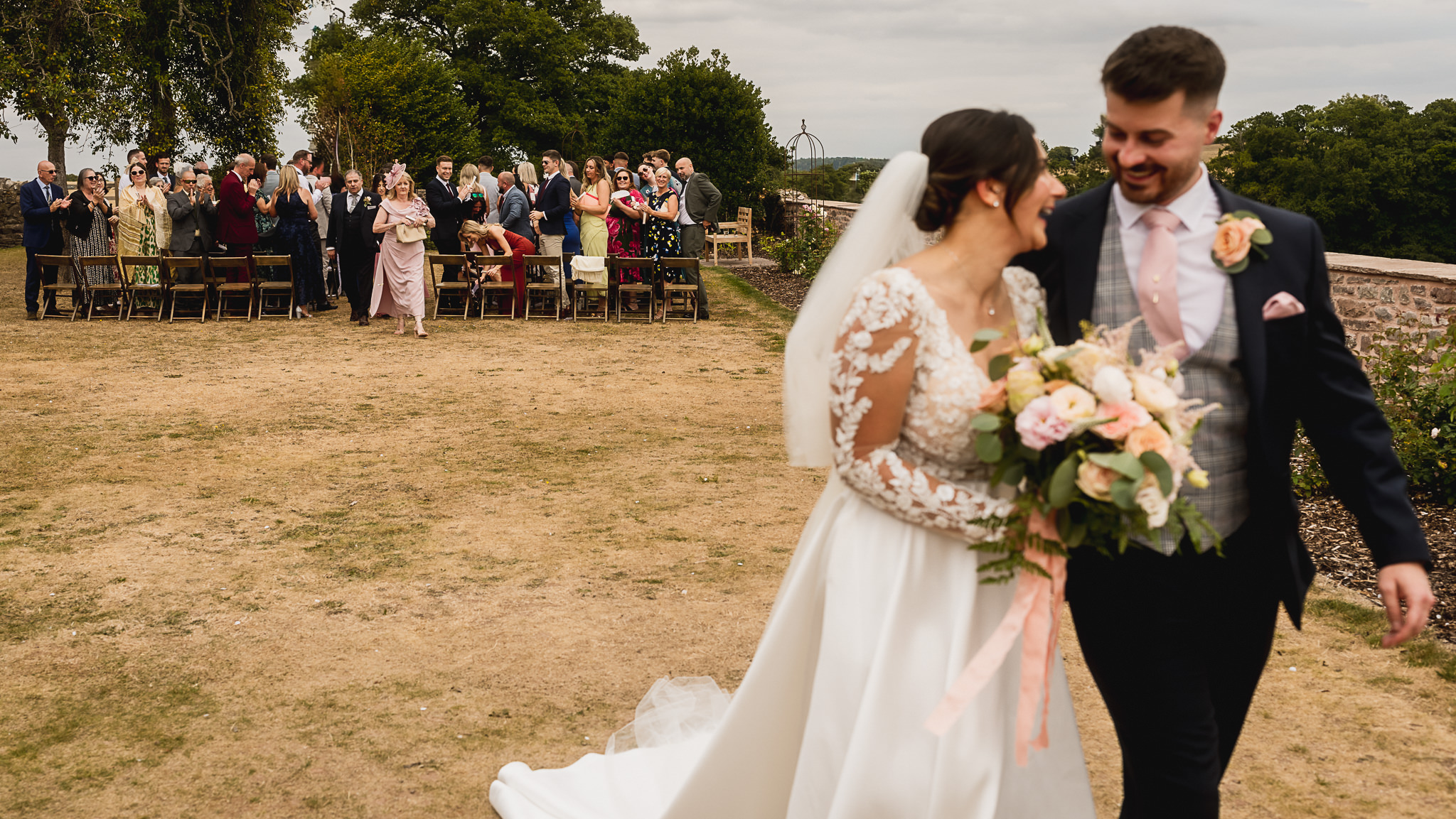 Outdoor ceremony beside the farmhouse at Llantilio House