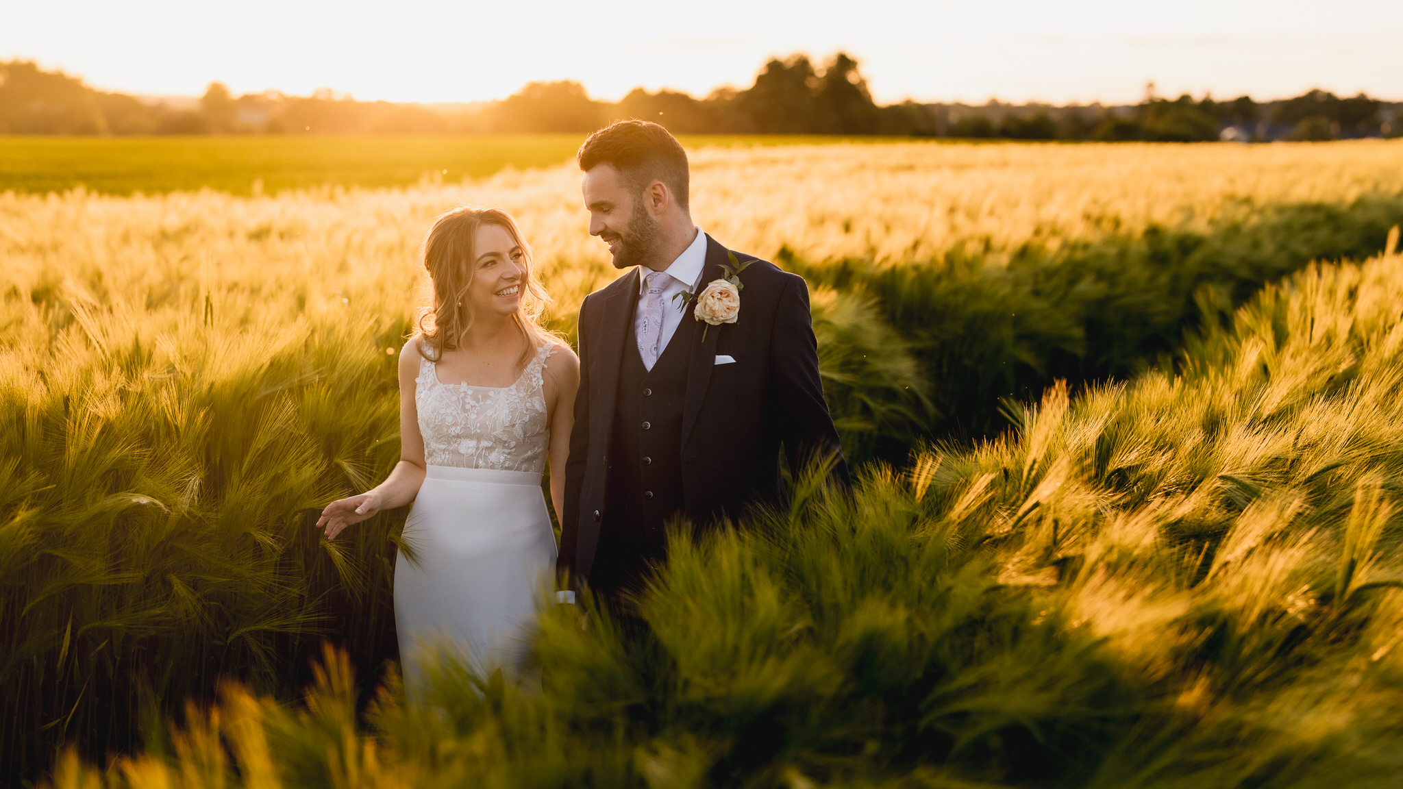 Rachel and Cameron in the barley beside the Great Tythe Barn
