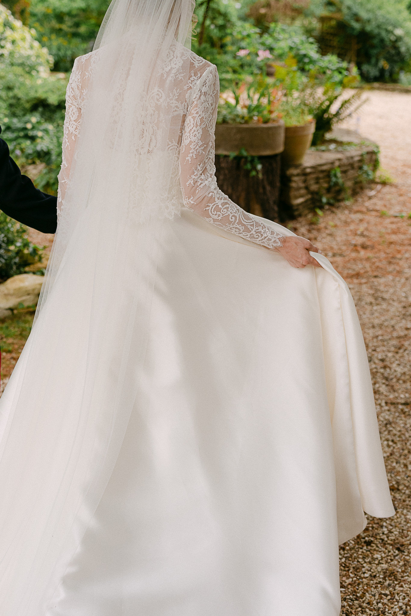 Bride walking across the courtyard in her dress