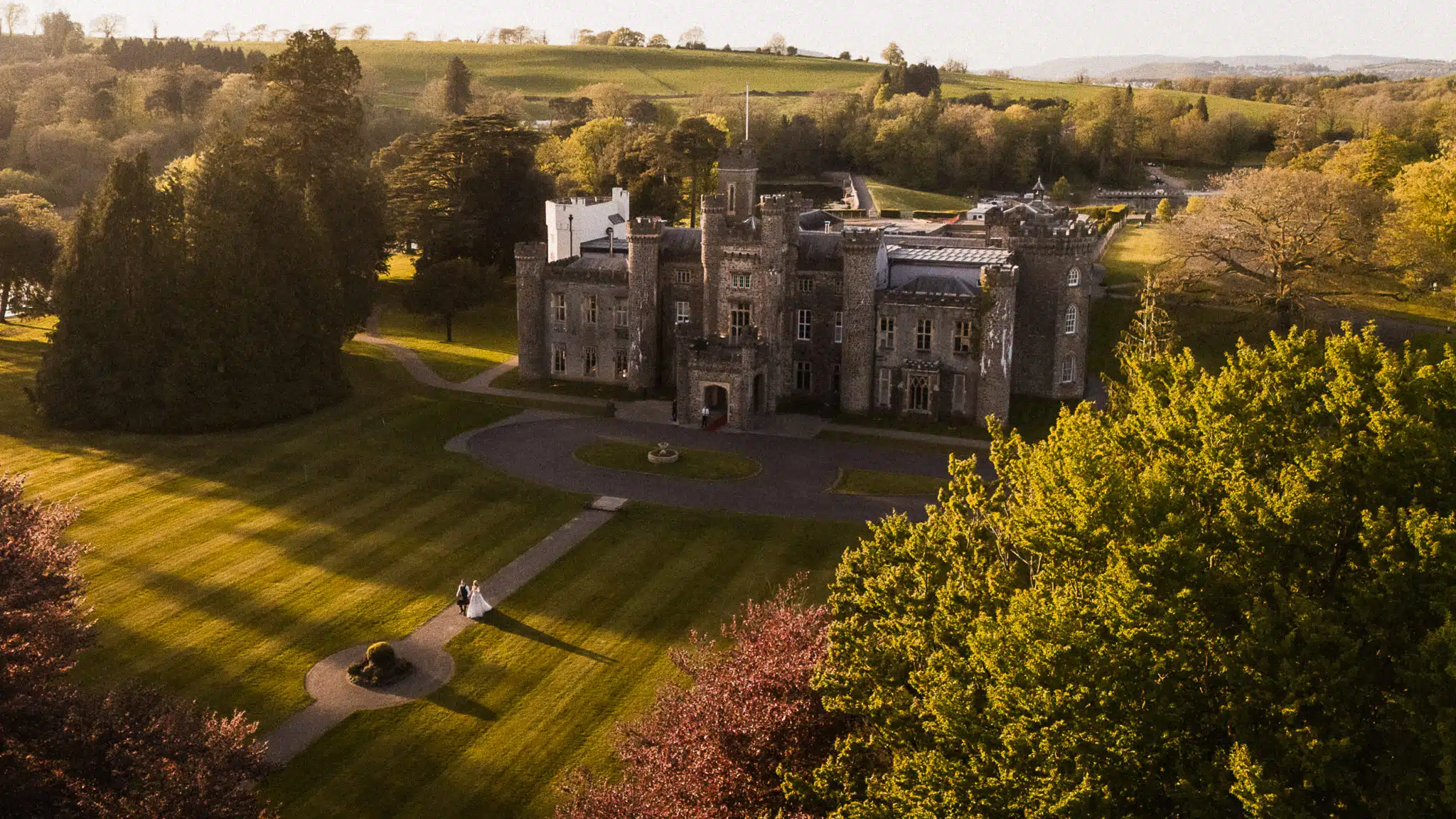 Hensol Castle from above in the evening light, the drive and lawns leading to the front door