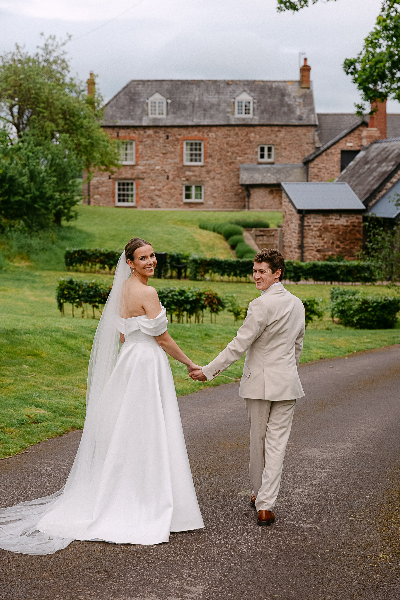 Couple walking the lane in front of Llantilio House