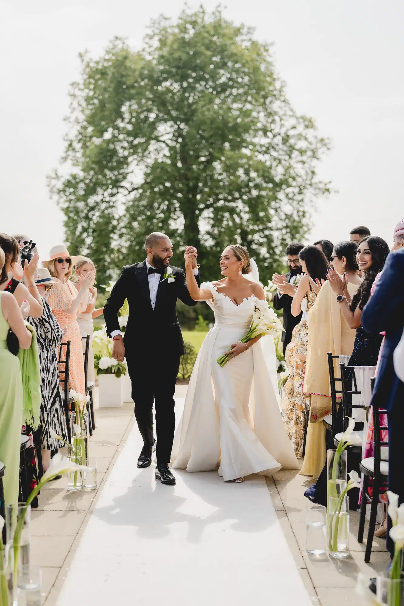 Bride and groom celebrating as they walk back down the aisle