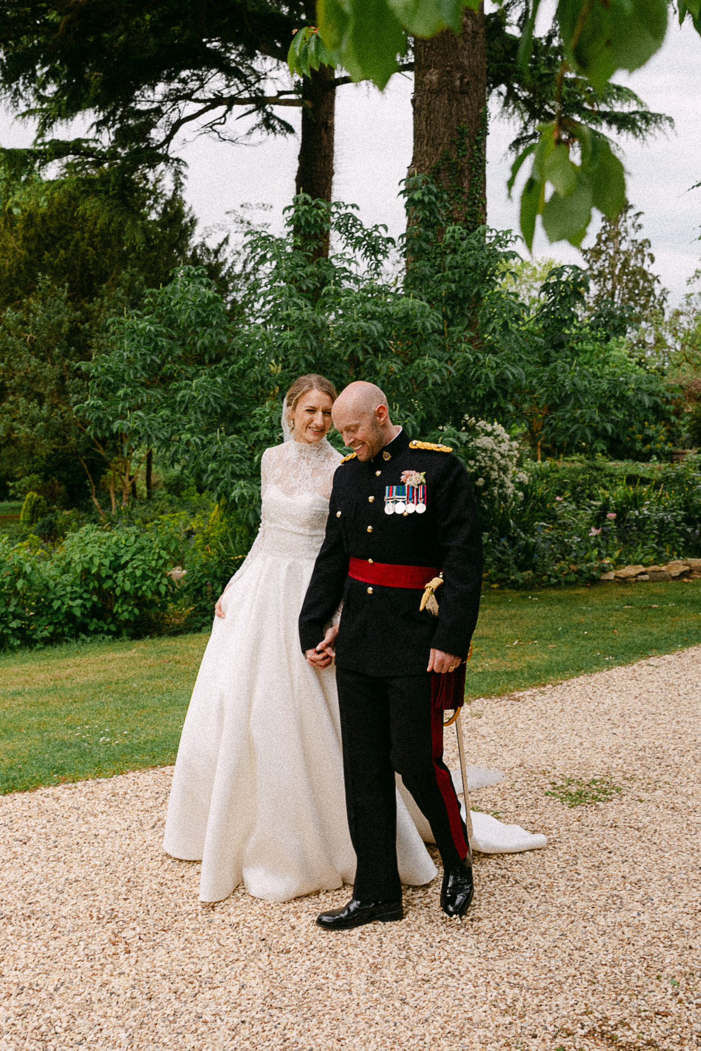 Bride walking arm in arm with her father in uniform