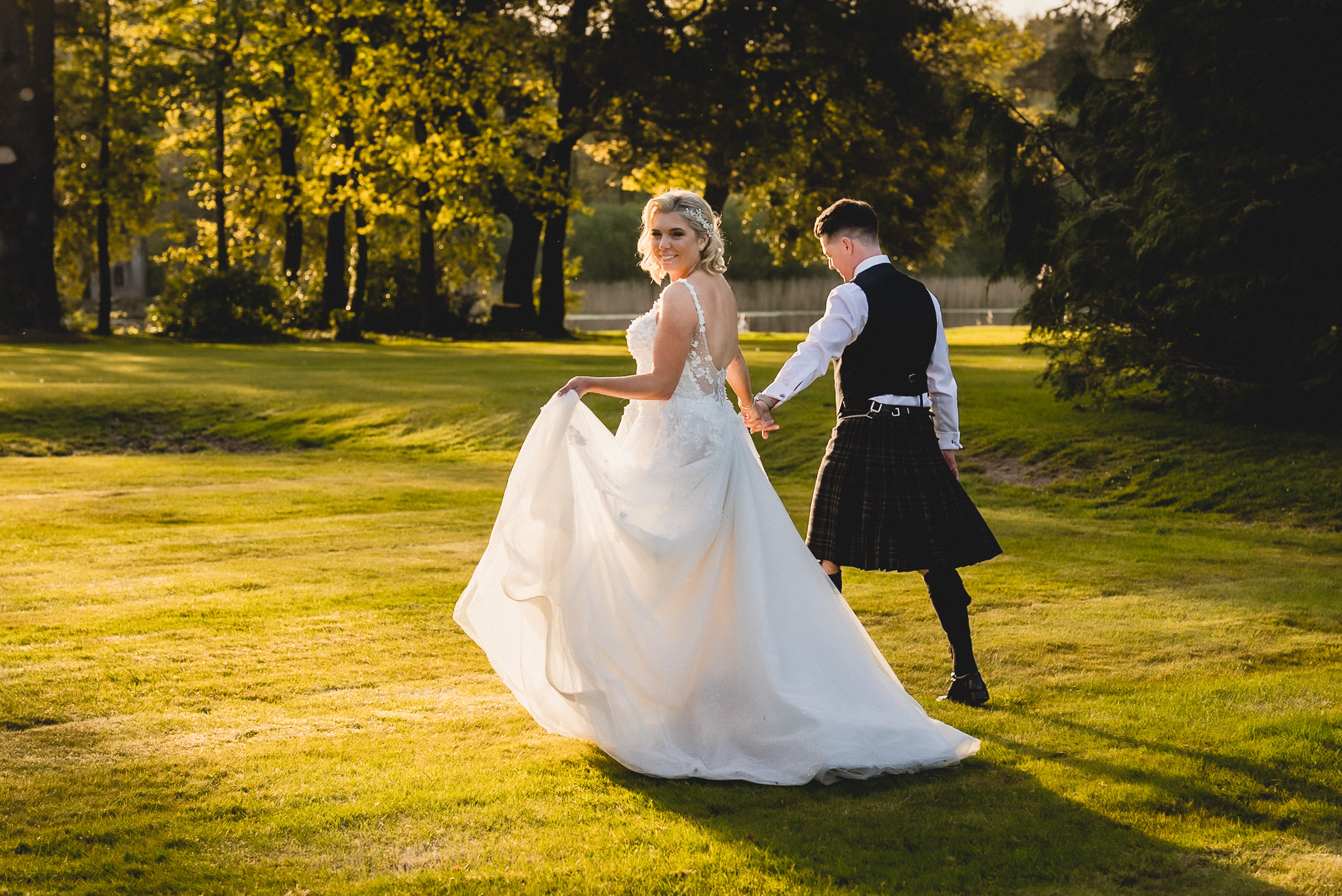 Sarah and Jamie crossing the lawn in the last light