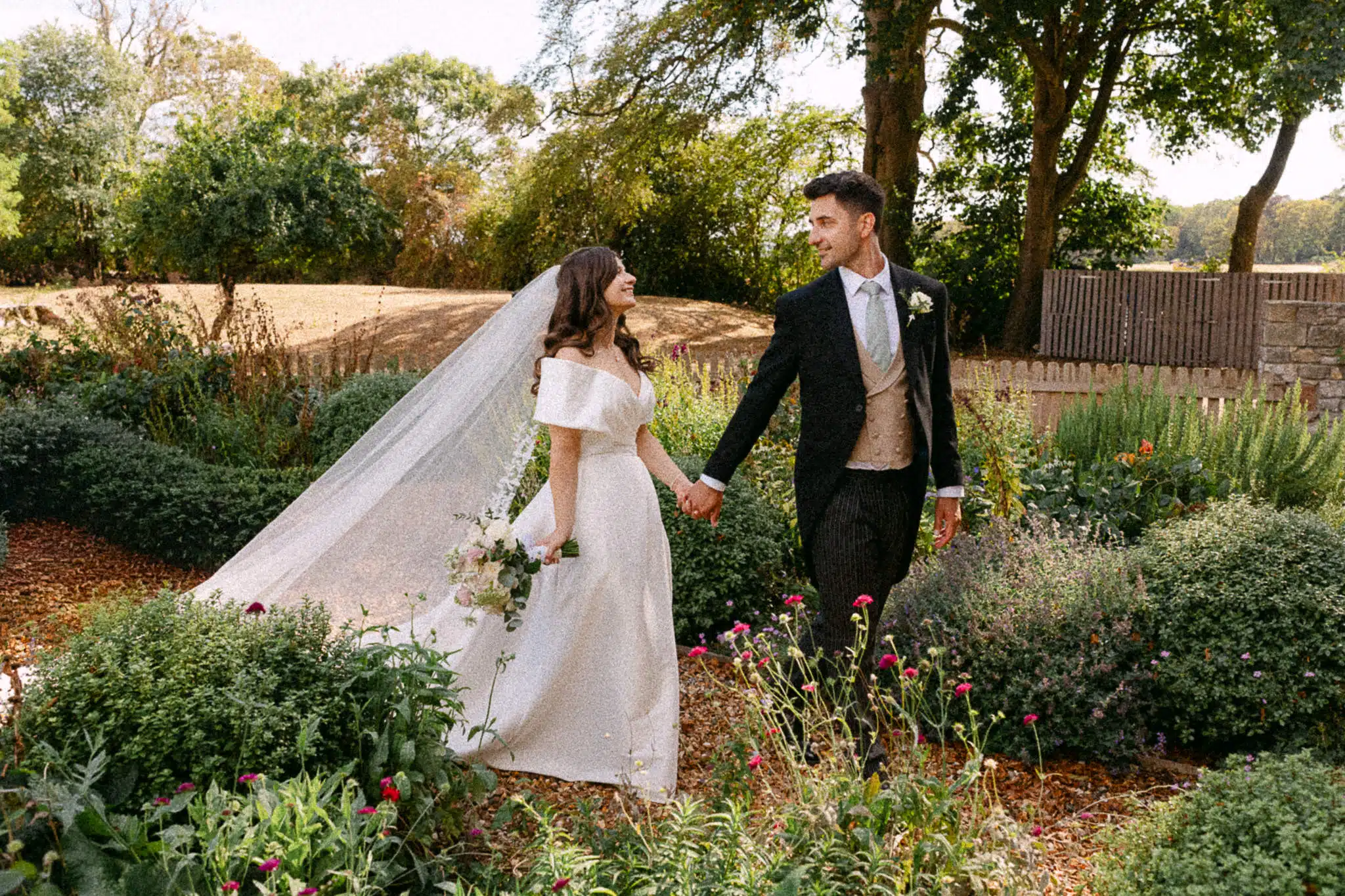 Jess and Tom walking through the gardens at St Tewdrics House