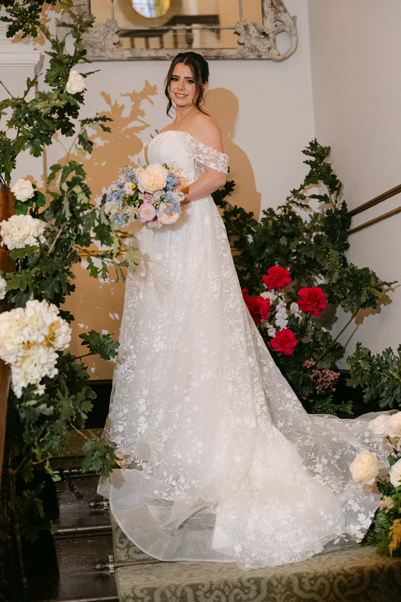 Bride on the staircase among the flowers
