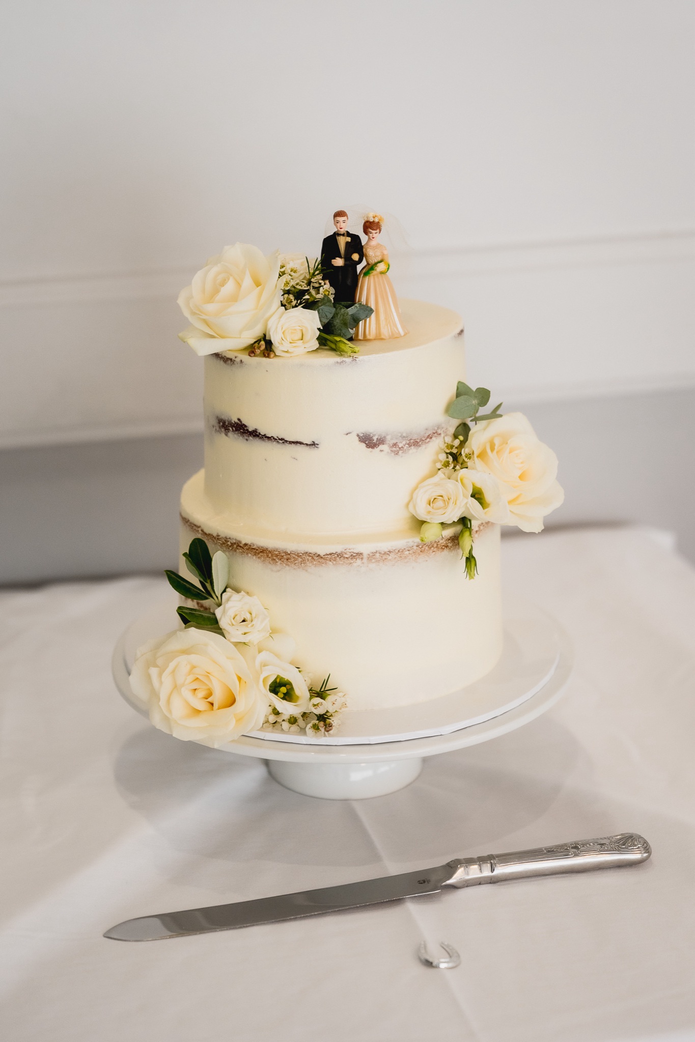Three-tier cake with fresh flowers