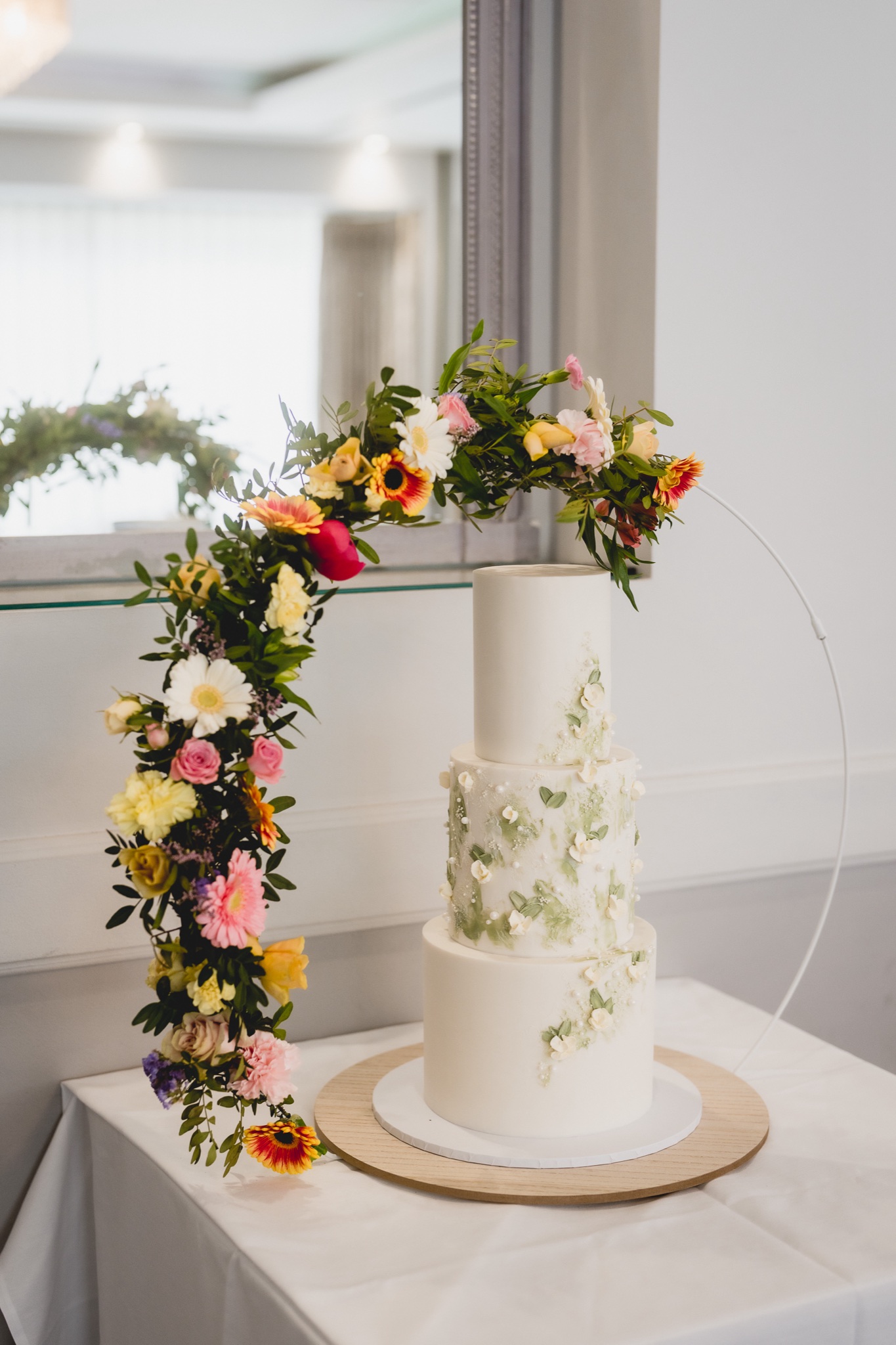 A flower-wrapped wedding cake at Hensol Castle