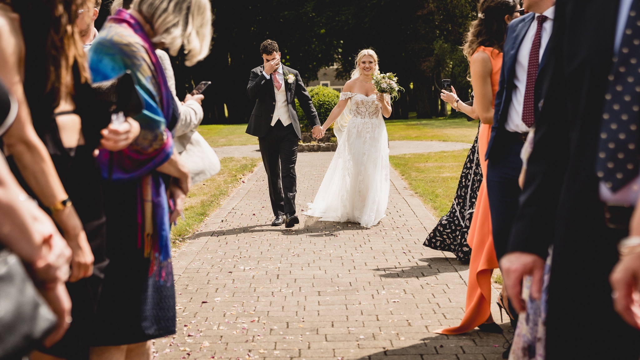 Jenny and Jason walking out through their guests