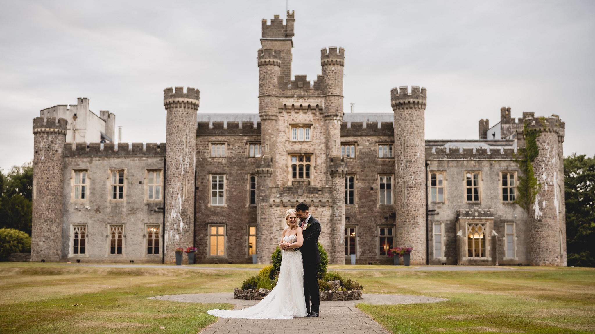 Jenny and Jason on the lawn in front of Hensol Castle