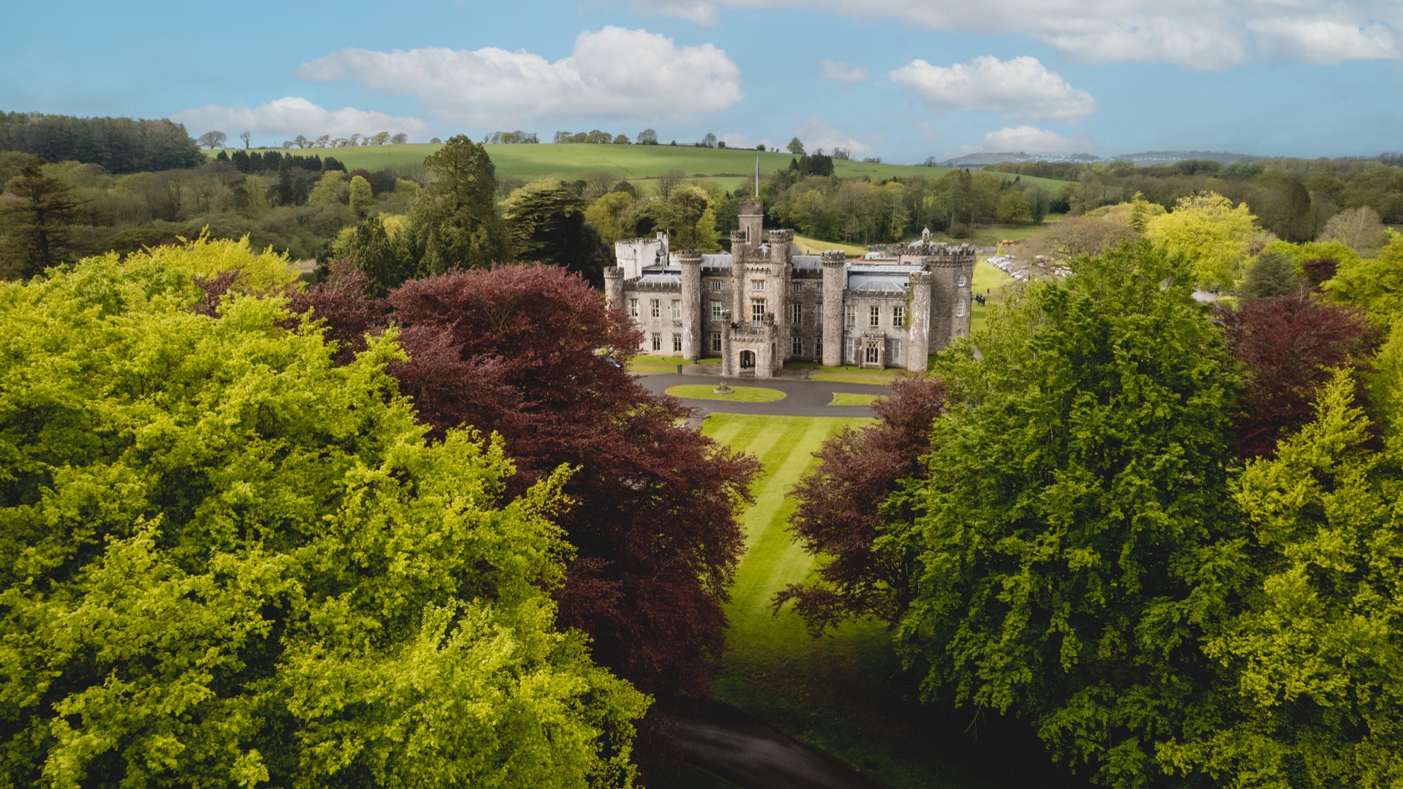 Hensol Castle and its lake from above in early summer