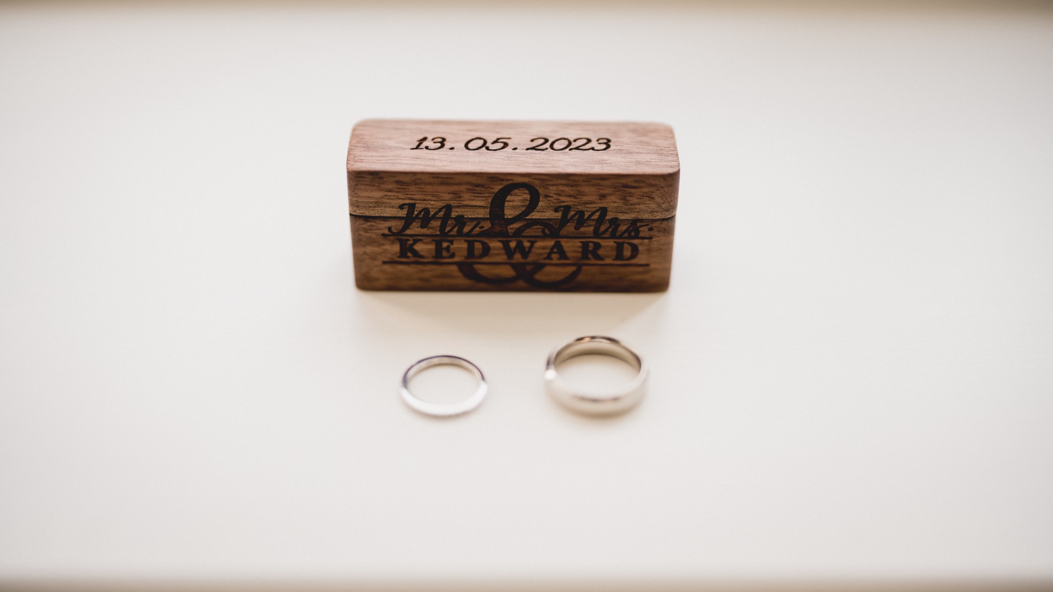 Wedding rings on a wooden box engraved with the date