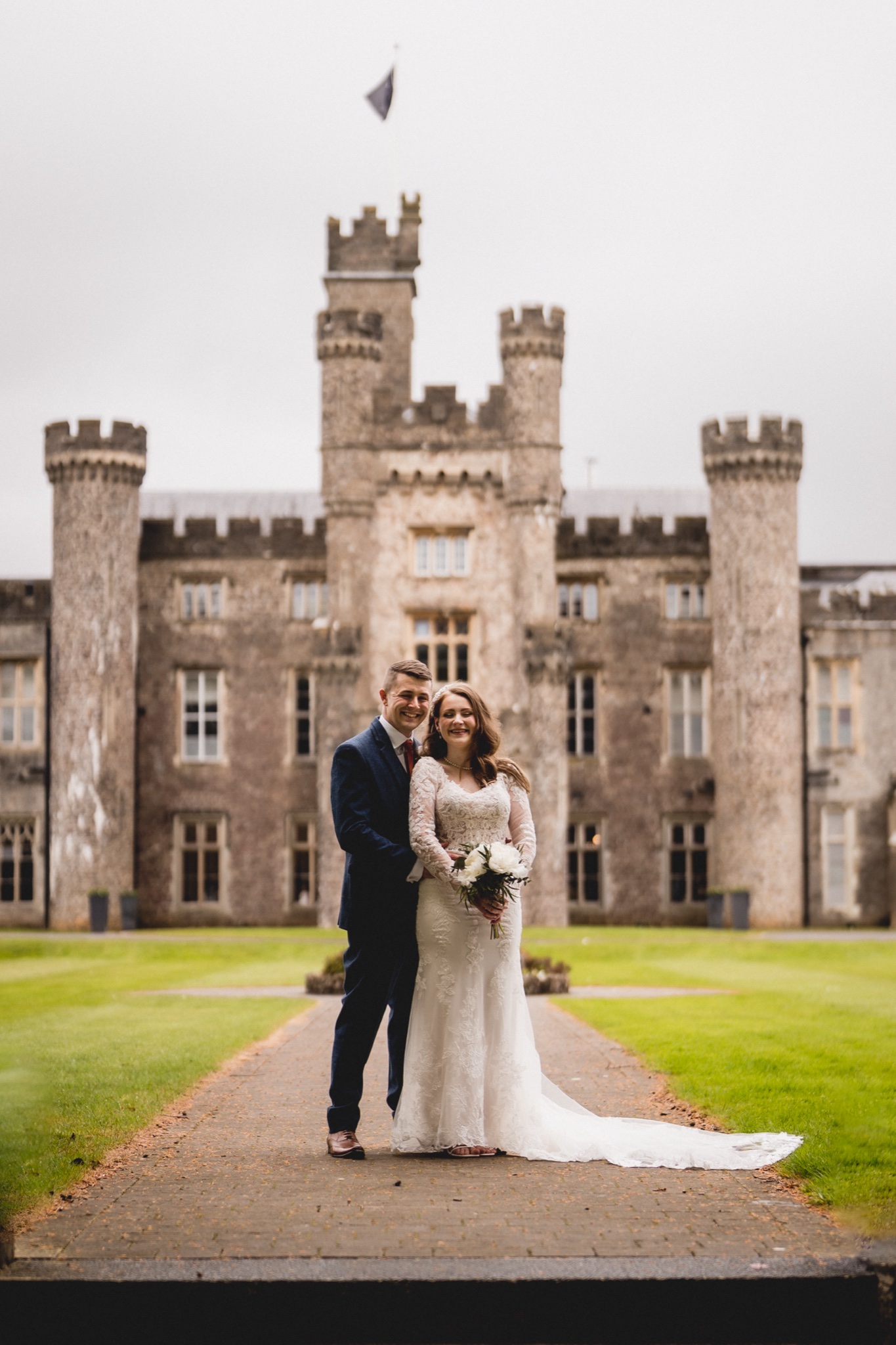 Maisie and Liam on the drive with the castle behind, in spring
