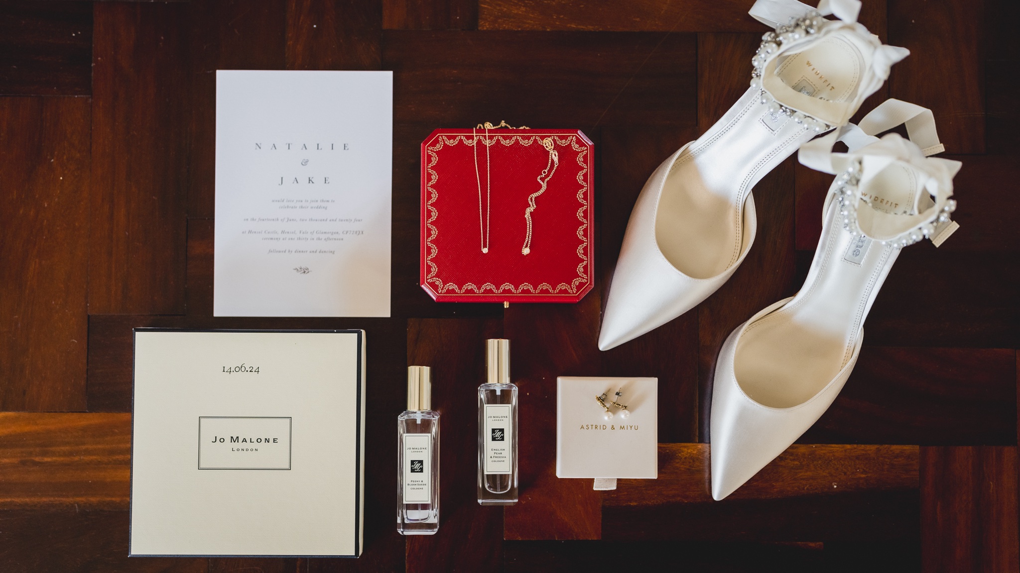 Invitation, necklace box and shoes laid out