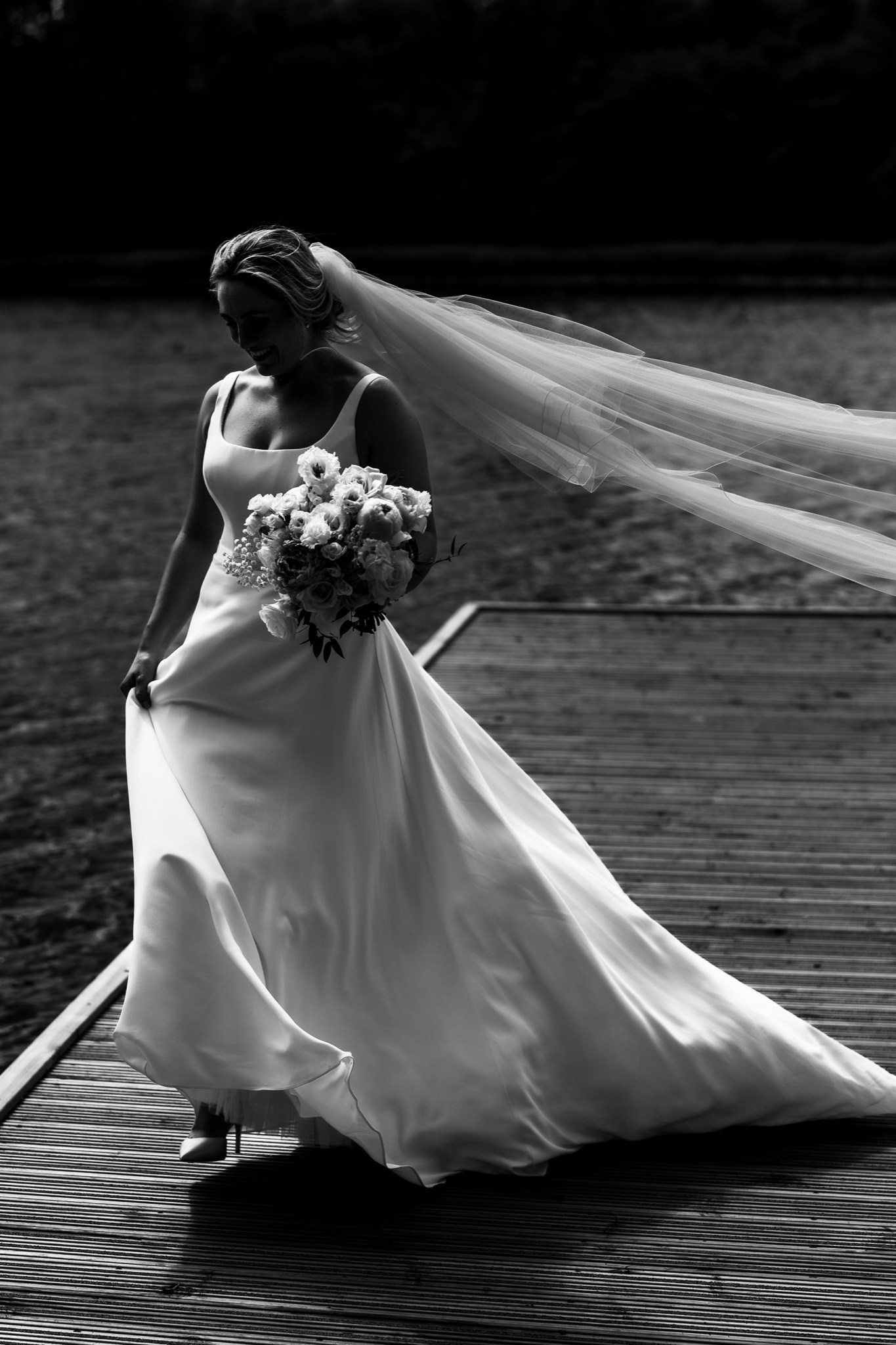 Natalie on the jetty with her veil, in black and white
