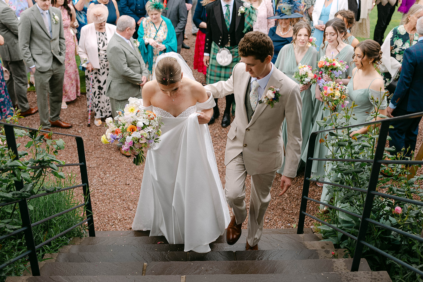 Olivia and Nathan climbing the stone steps through their guests