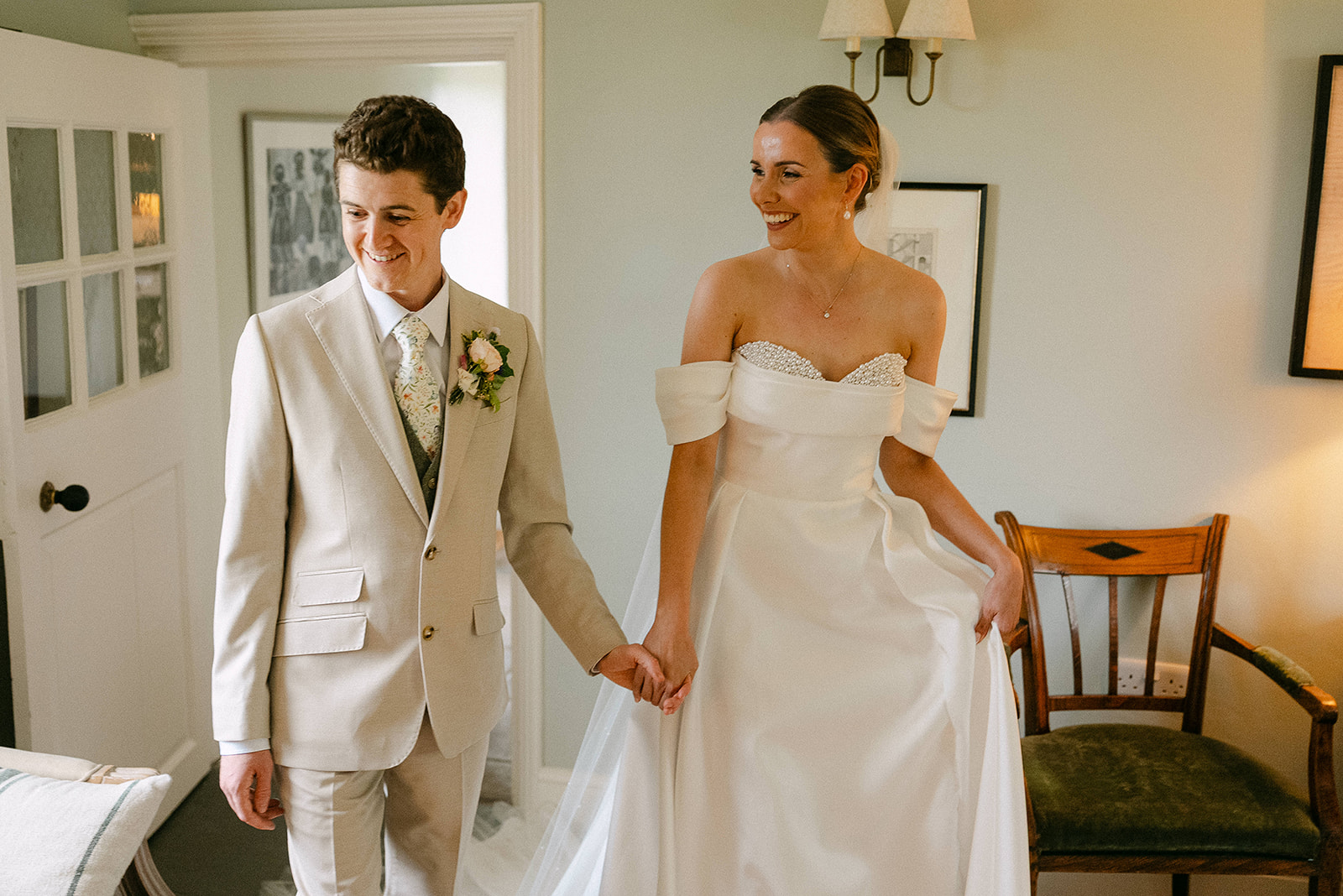 Olivia and Nathan holding hands in the farmhouse