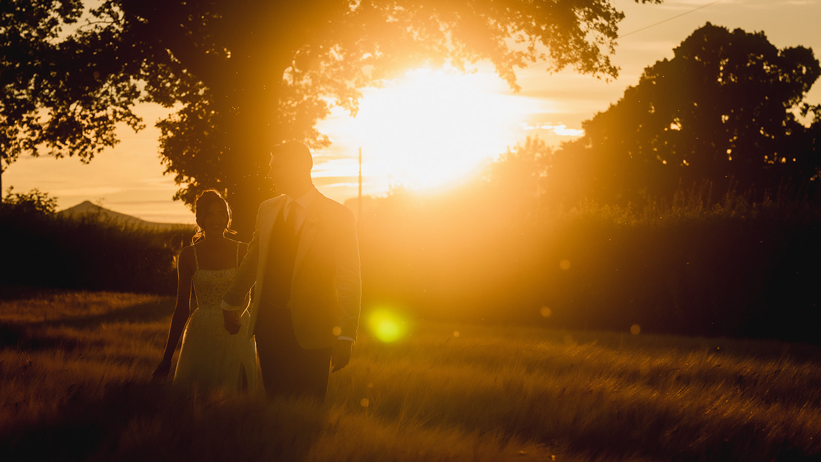 Rosie and Ben under the old tree in the field as the sun sets