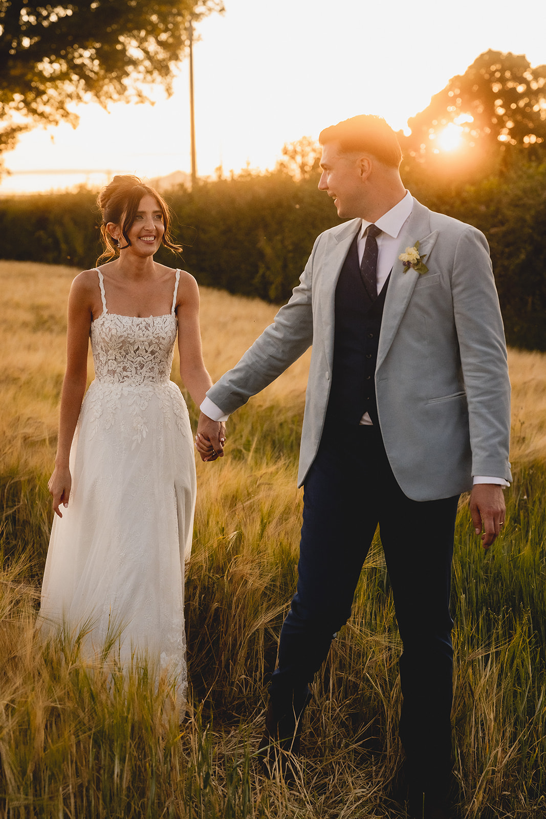 Rosie and Ben walking through the field in the evening light