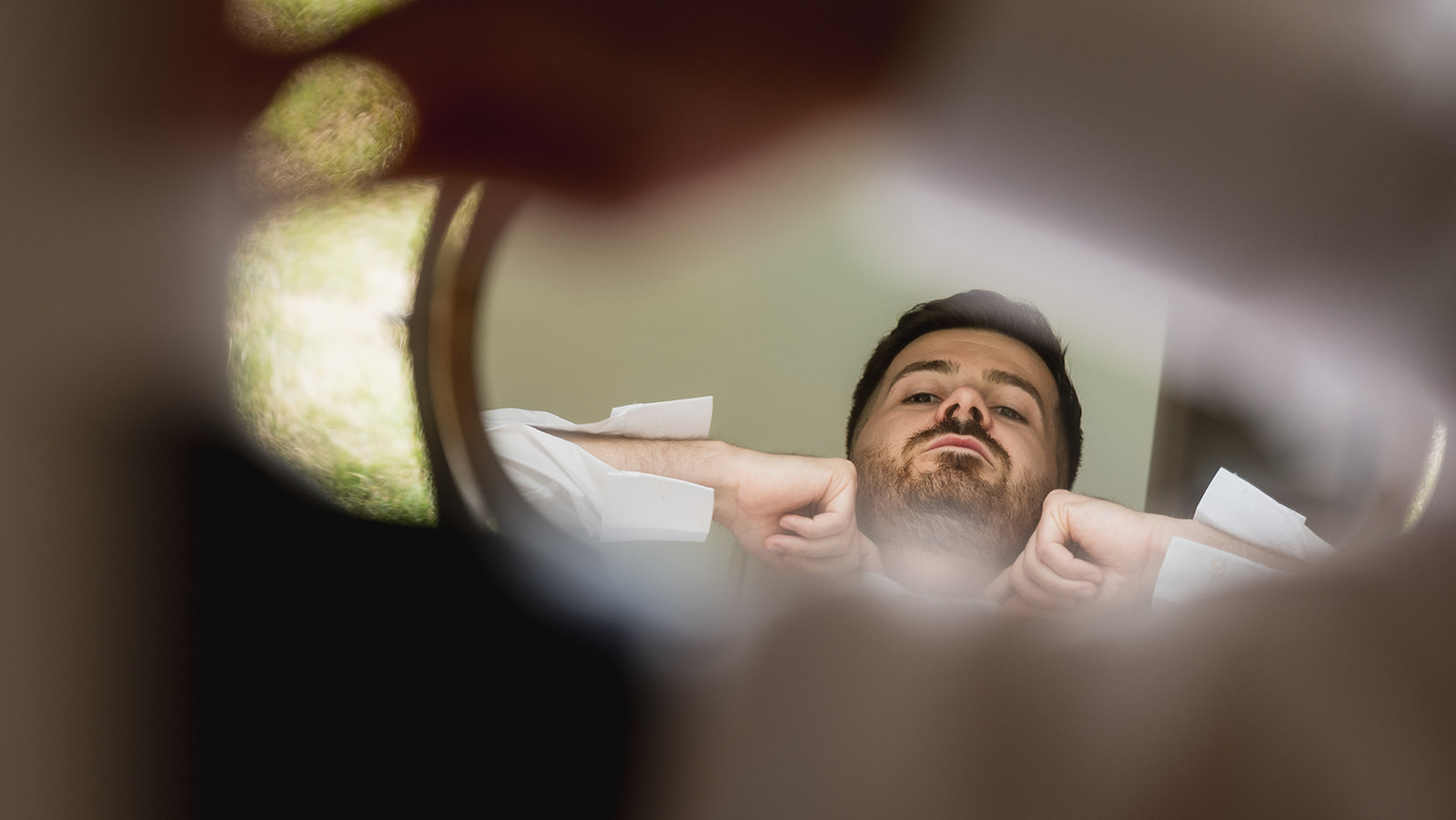 Josh reflected in a small mirror as he gets ready