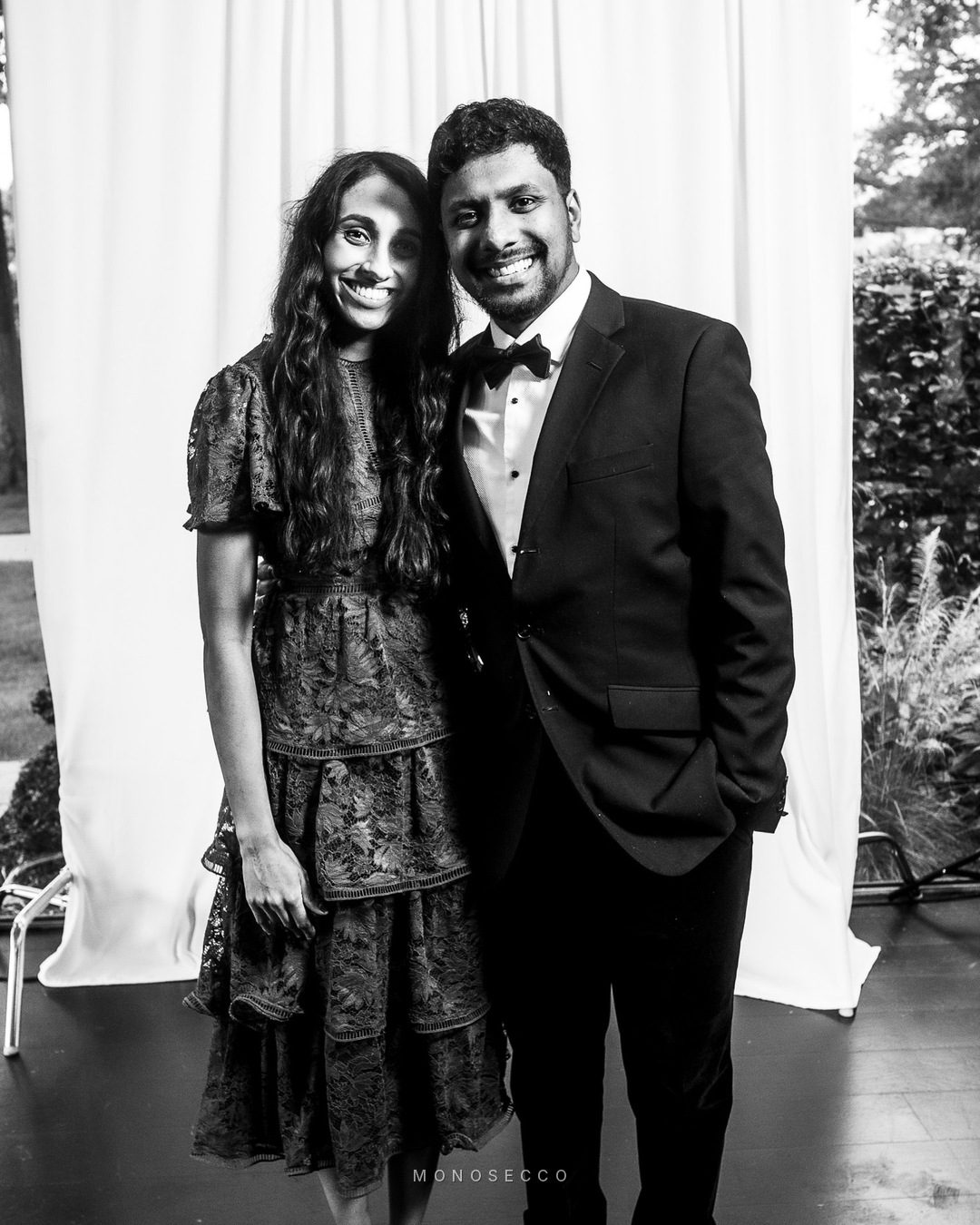 A couple standing close together in evening dress