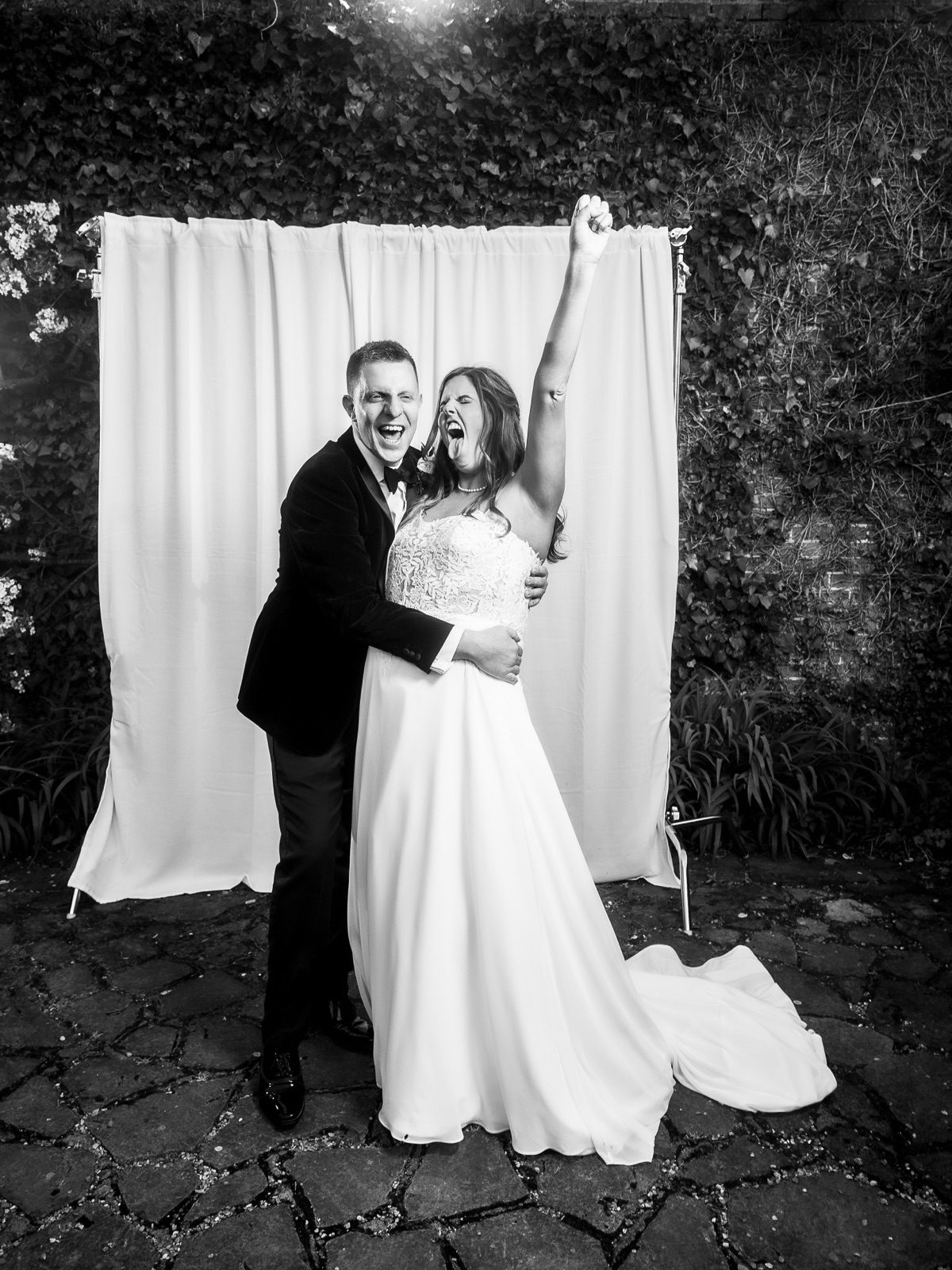 Bride and groom cheering with their arms in the air