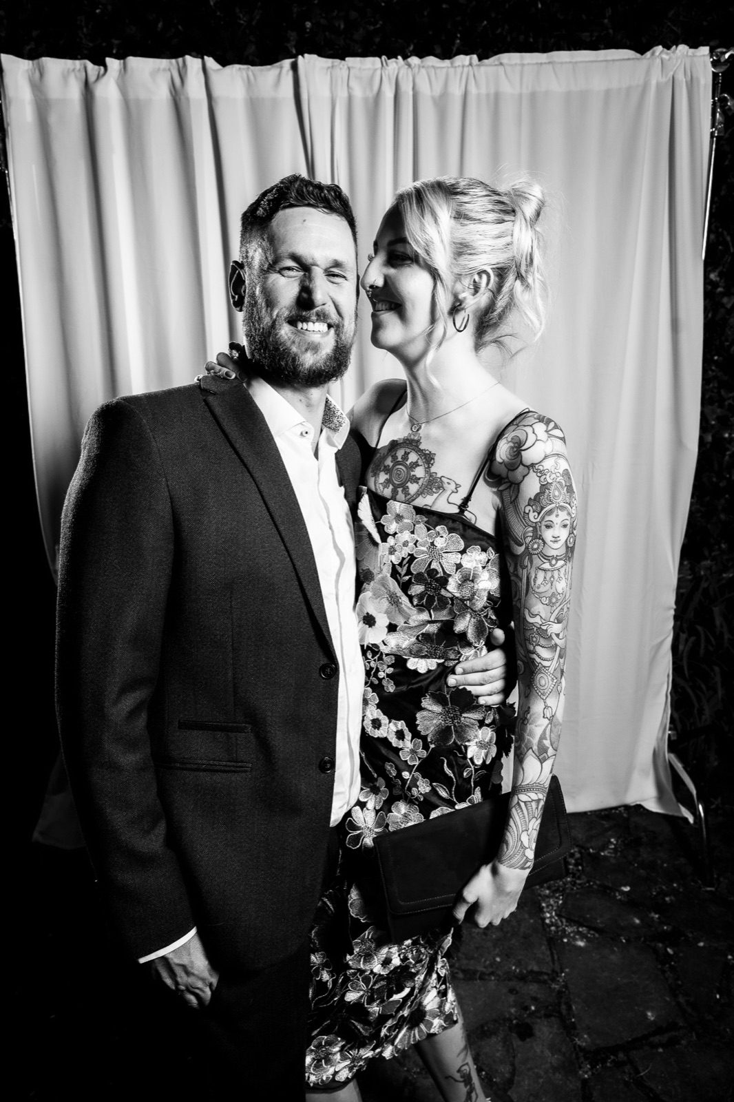 A couple leaning in close, black and white evening portrait