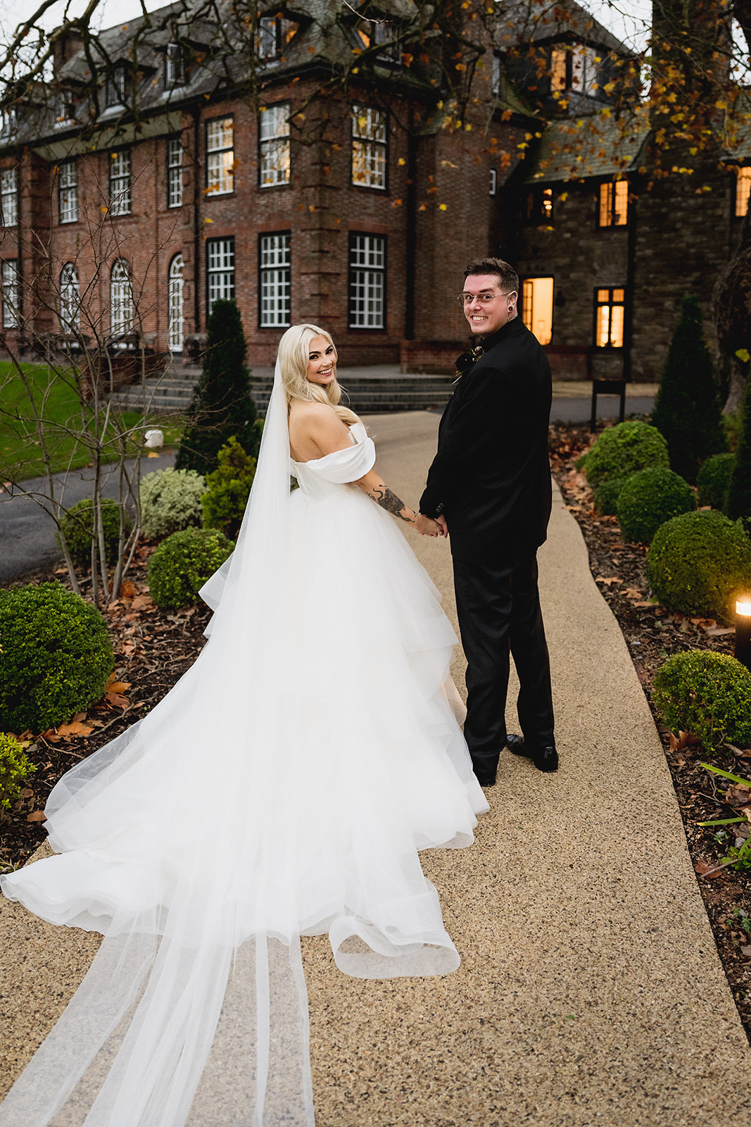 Karrie and Rafe on the path with the house behind them