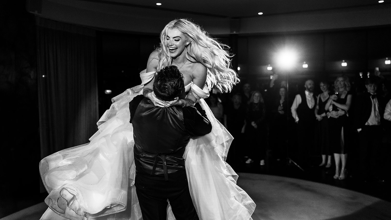 Rafe lifting Karrie during their first dance, in black and white