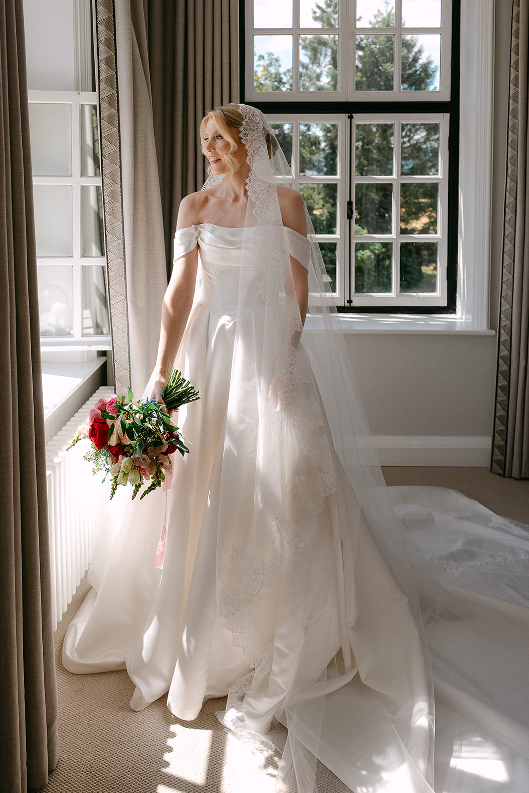 Kate in her dress by the tall bedroom window