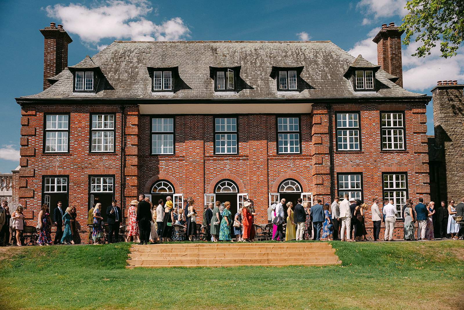 Guests gathered on the lawn in front of the house