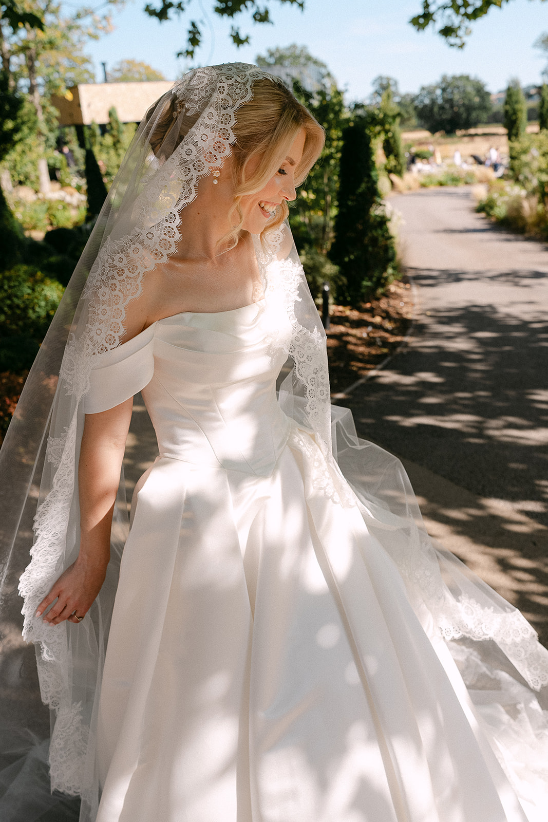 Kate’s veil catching the light on the garden path