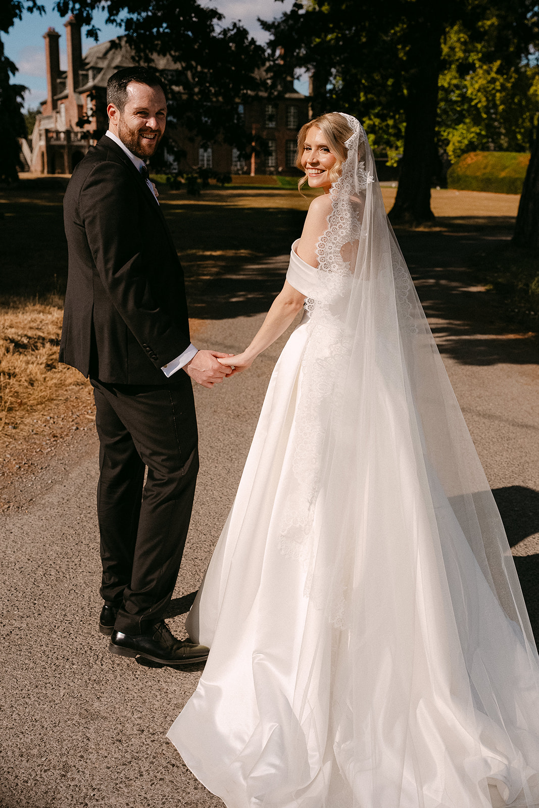 Kate and Dylan holding hands on the drive