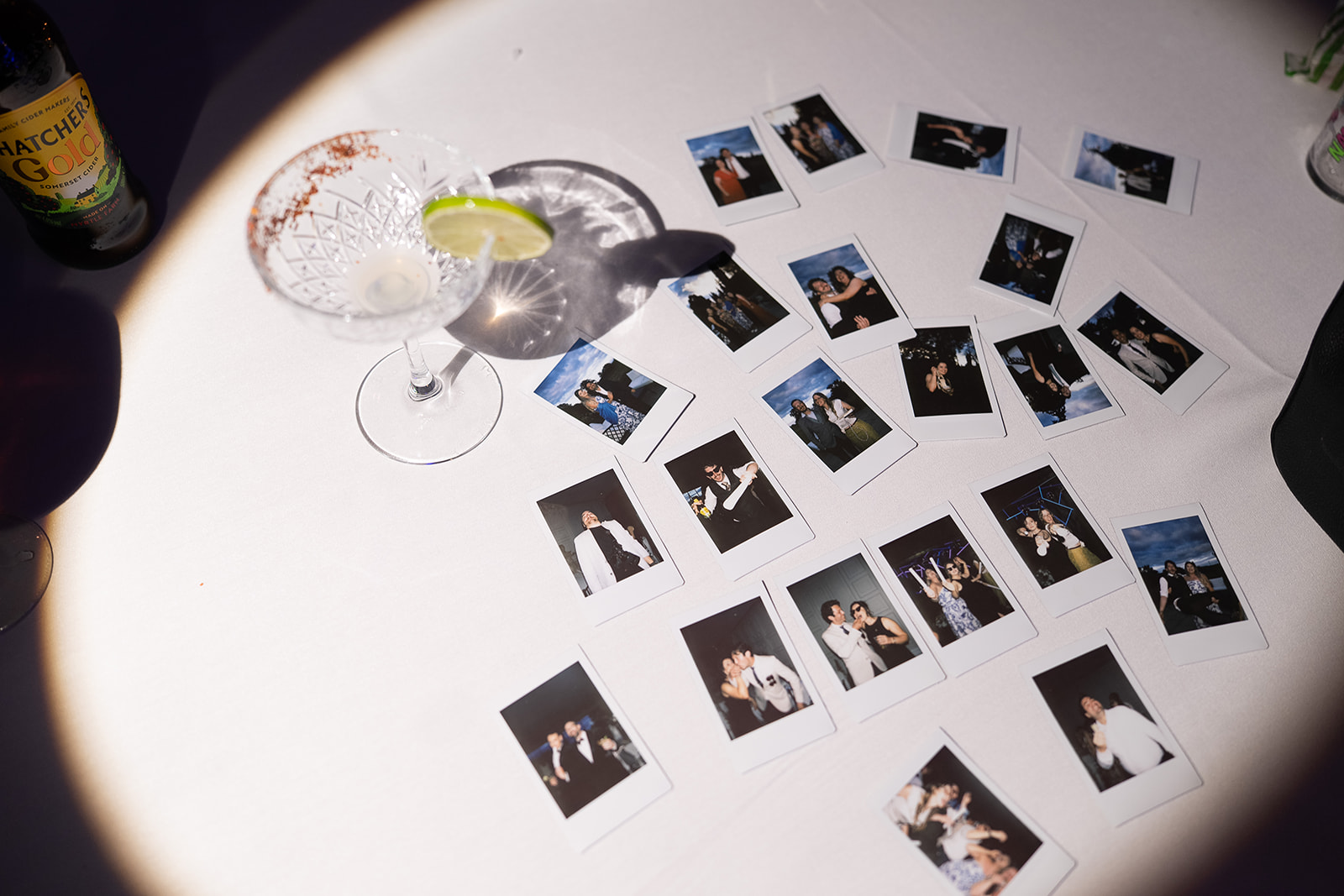 Instant photos scattered across a table at the party