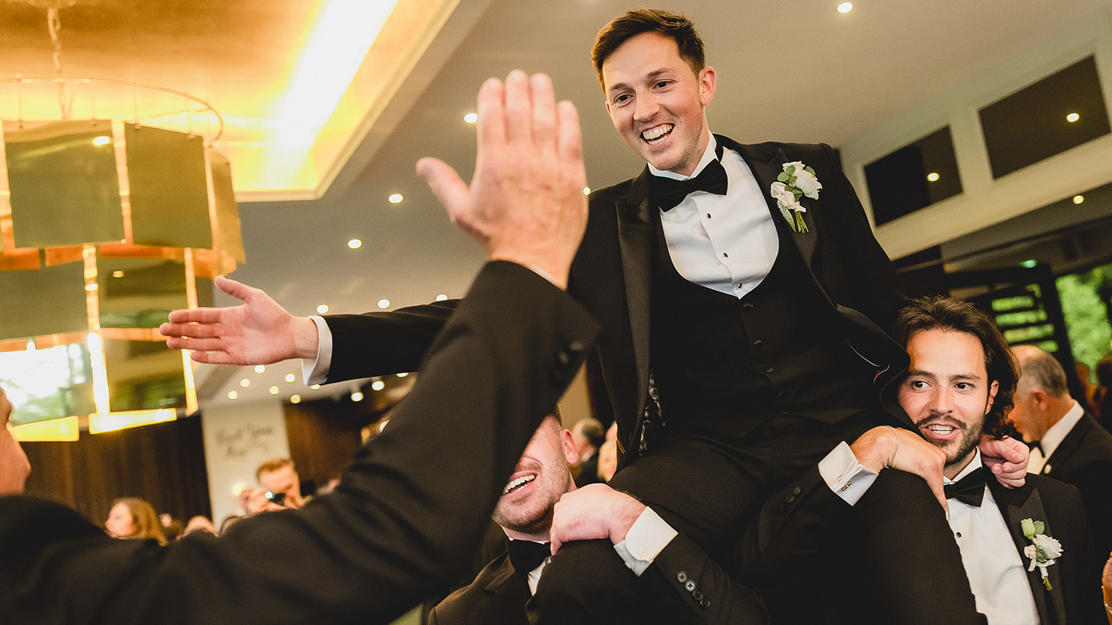 Nick lifted onto shoulders on the dance floor